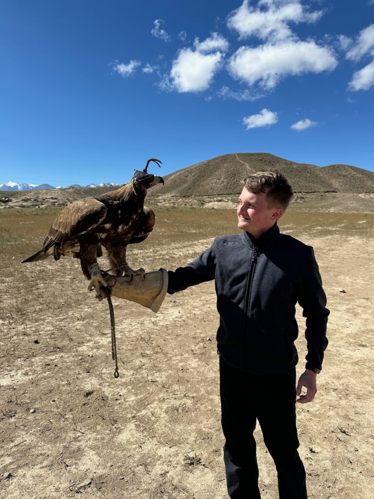 Victor Skade fra Vores Verdenshjørner med en ørn på armen under en oplevelse med nomadekultur i Kasakhstan